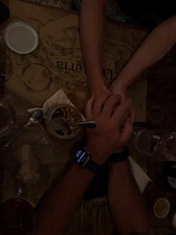Couple shares intimate dinner moment at dimly lit restaurant