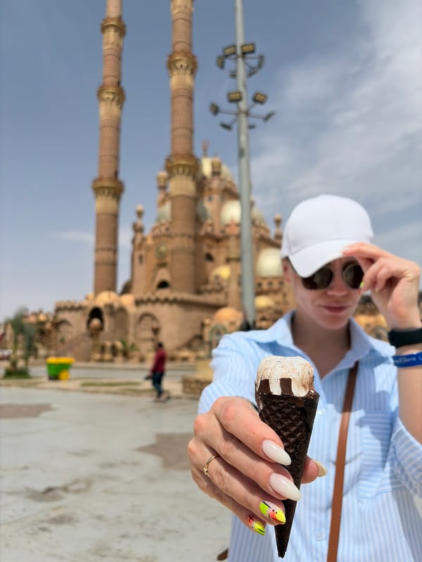 Tourist enjoys ice cream while sightseeing at Egyptian mosque