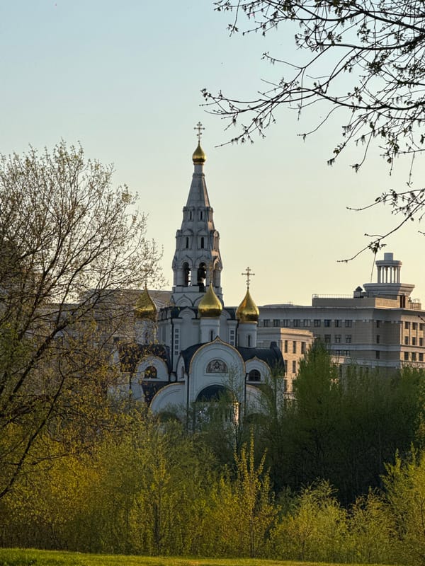 Moscow spring afternoon captured through urban architecture and blossoming trees