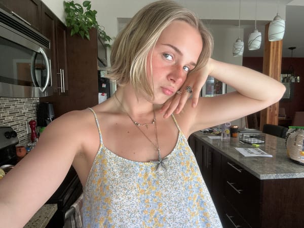 Woman in floral dress observed in Whistler kitchen