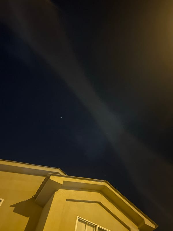 Nighttime building exterior captured under cloudy sky in Ecuador