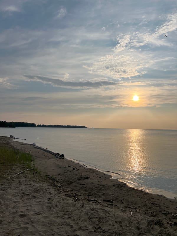 Calm sunset evening on the Borovoe shoreline with moored inflatables