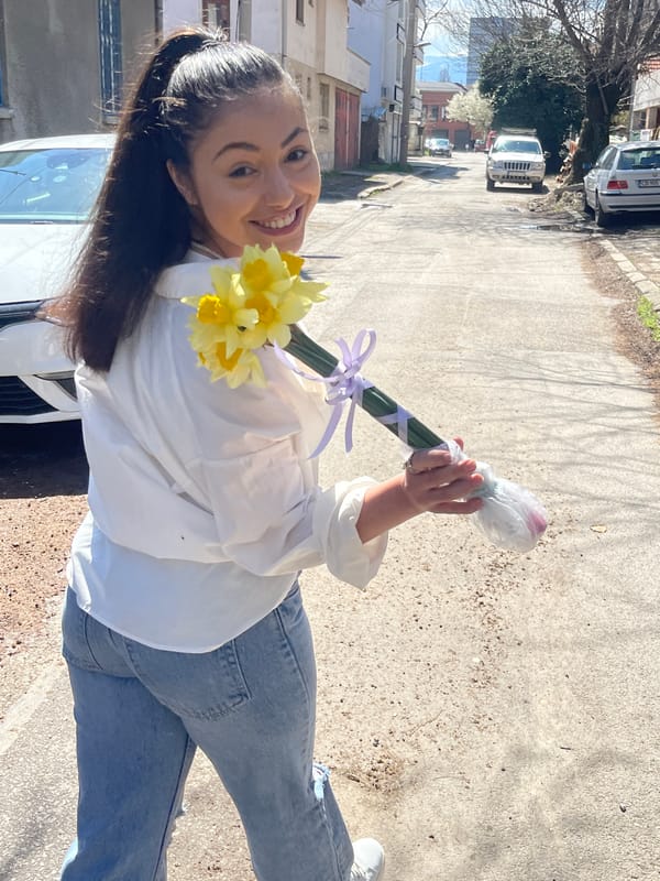 Young woman holds flower bouquet on Sofia street