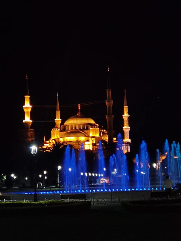 Evening tourist documentation of illuminated Blue Mosque and Sultanahmet landmarks