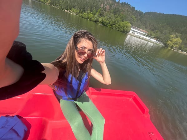 Woman takes selfie in red paddle boat on Bulgarian lake