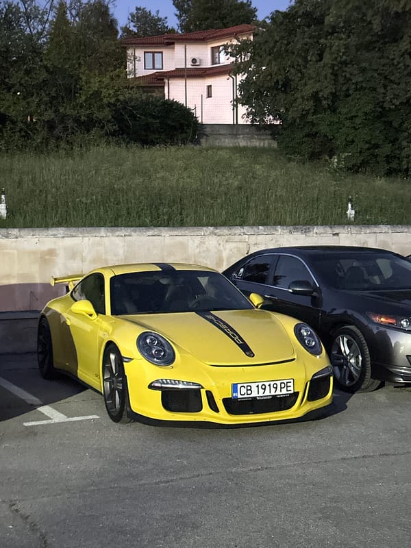 Two Porsches parked at dusk in Arbanassi, Bulgaria