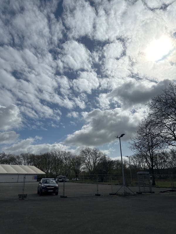 Young man poses in Essen parking lot amid construction