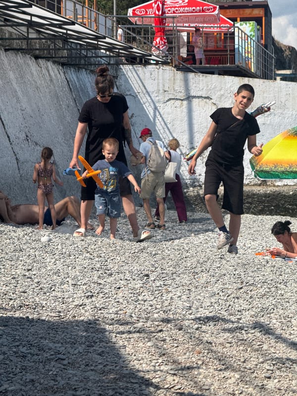 Families enjoy sunny afternoon at pebble beach