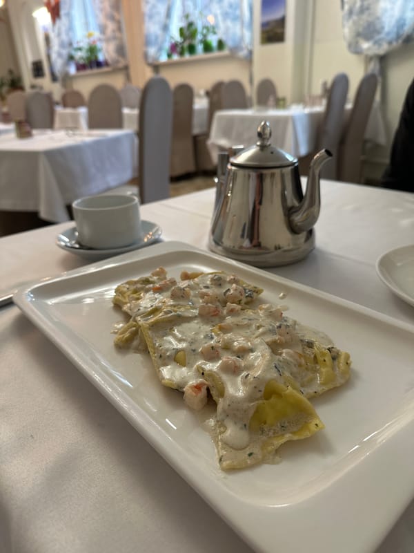 Lunch documented at upscale restaurant with pasta and pizza