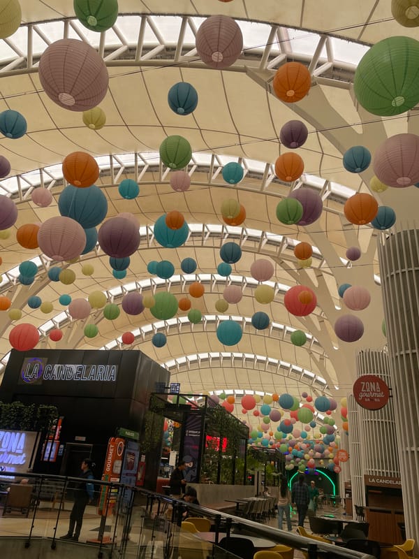 Colorful paper lanterns decorate commercial space ceiling in Caracas