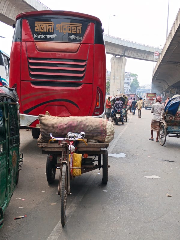 Morning street activity captured under Dhaka overpass