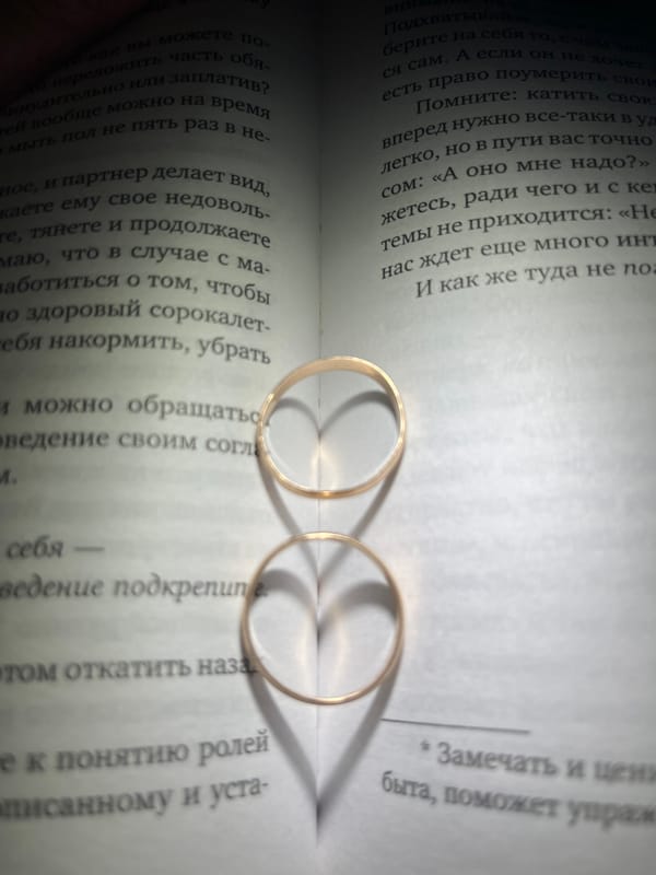 Wedding rings photographed on Russian book pages in Chaikovsky