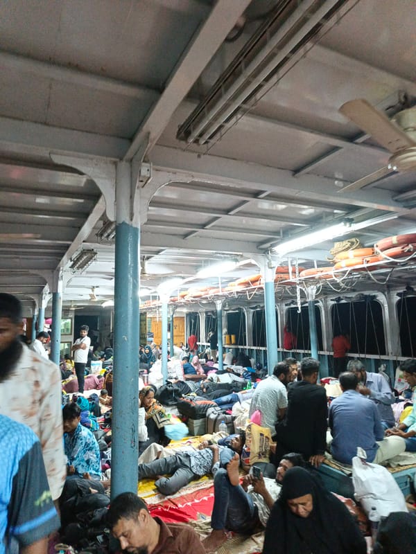 Ferry passengers play cards during river crossing in Bangladesh