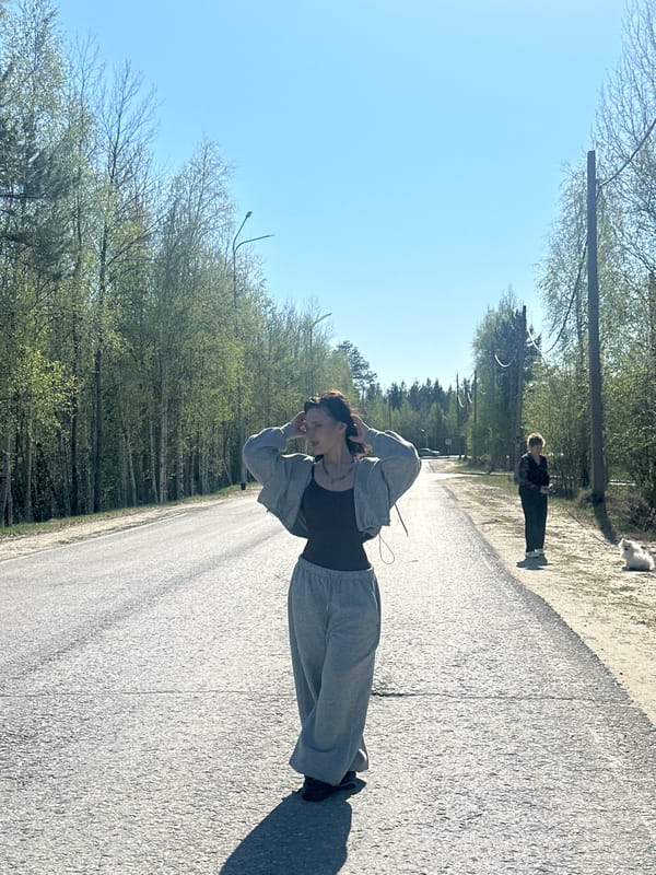 Two women take selfies outdoors in Высокий, Russia