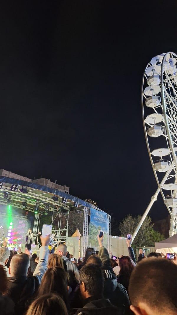 Crowd gathers with phones recording near Ferris wheel in Plovdiv