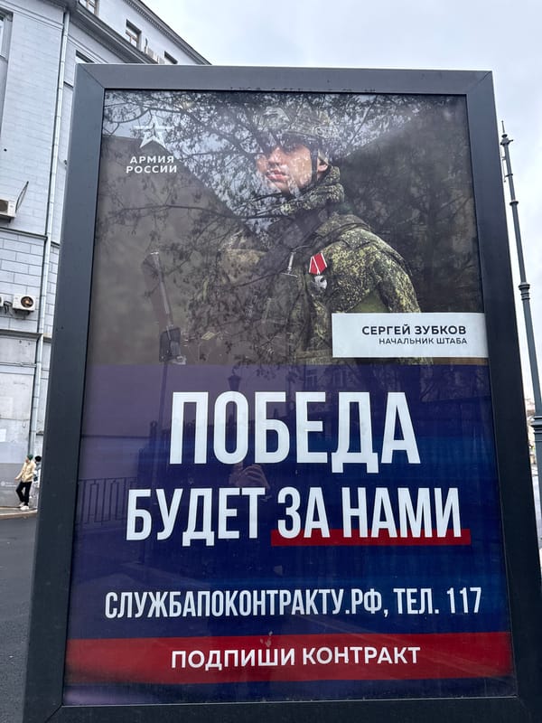 Moscow street scenes captured featuring billboard, buildings, golden-domed church