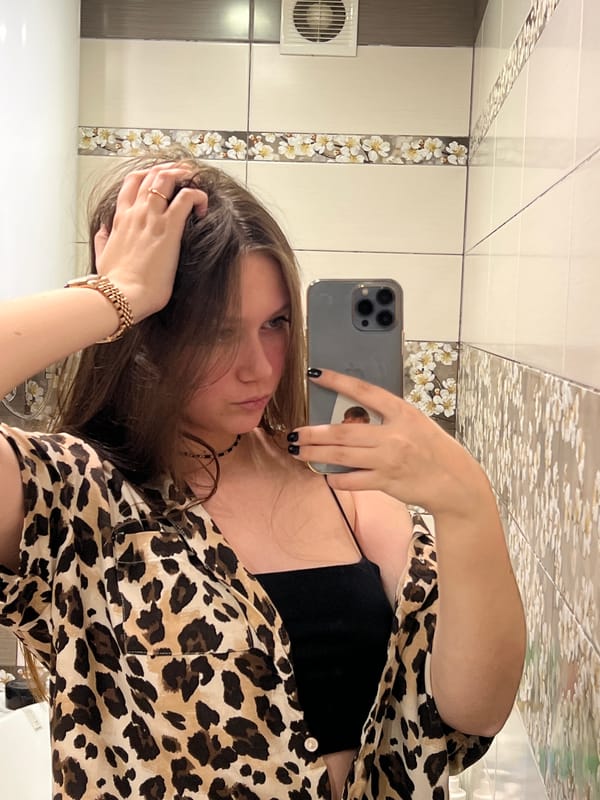 Woman takes multiple selfies in leopard print in Chaikovsky