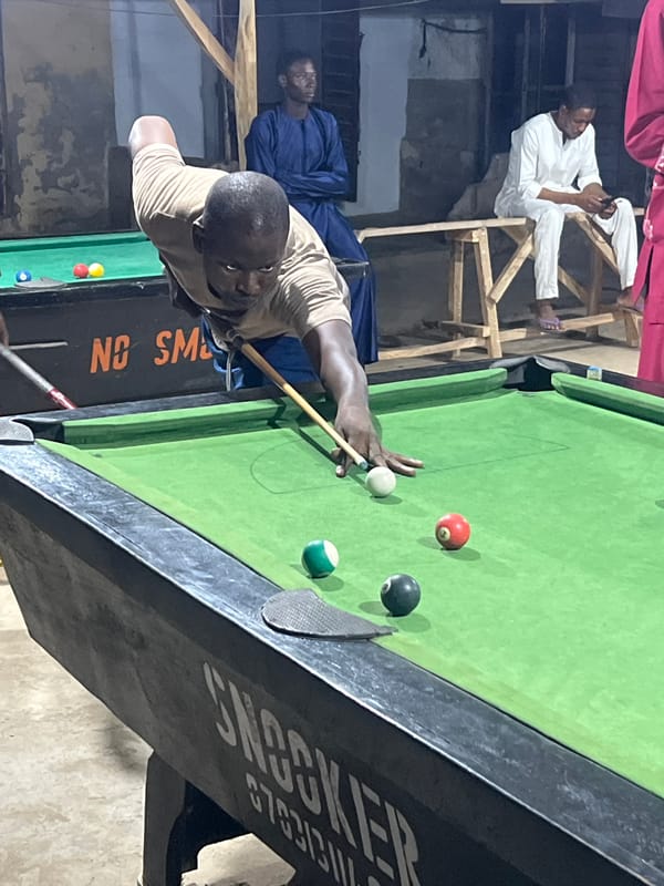 Evening pool games documented at Minna recreational hall
