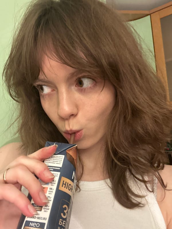 Young woman takes selfies during indoor photo session in Moscow