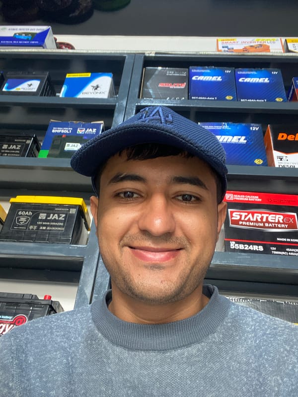 Man browses car batteries at Bukhara auto parts store