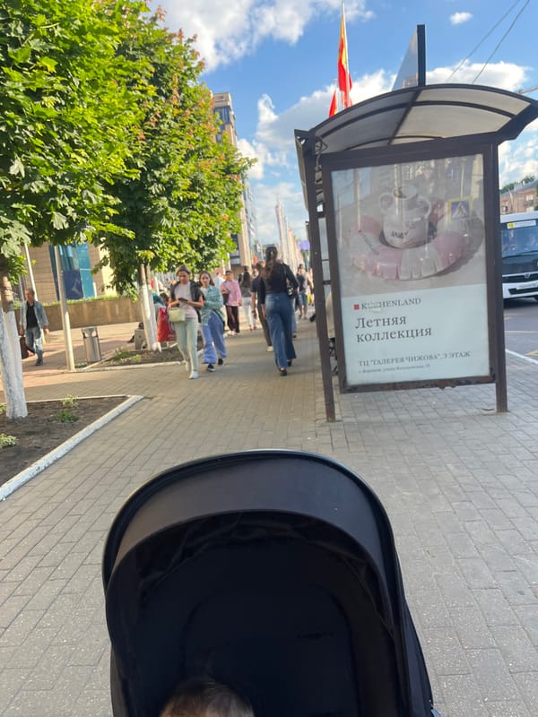 Quiet Voronezh street corner with bus stop and stroller