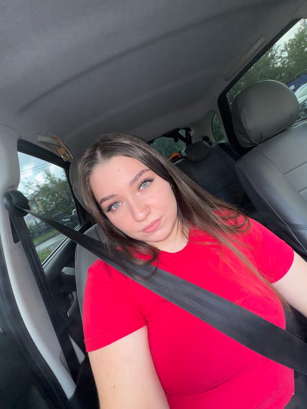 In-car selfie session in Perm, red t-shirt, June 2026