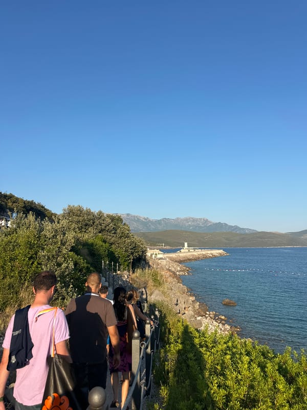 Afternoon along the Radovići waterfront, lighthouse and all