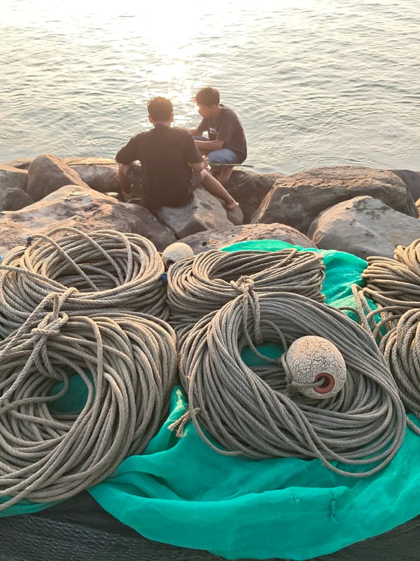 Sunset fishing and shoreline hangout on Lhokseumawe's rocky coast