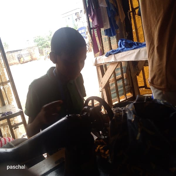 Young tailors work at sewing workshop in Nsugbe, Nigeria