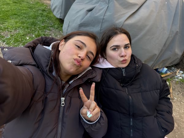 Two women take selfie on tarpaulin in Sofia