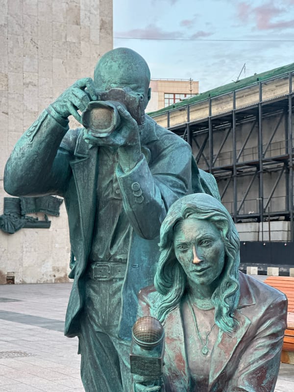 Bronze photographer monument observed on Moscow sidewalk