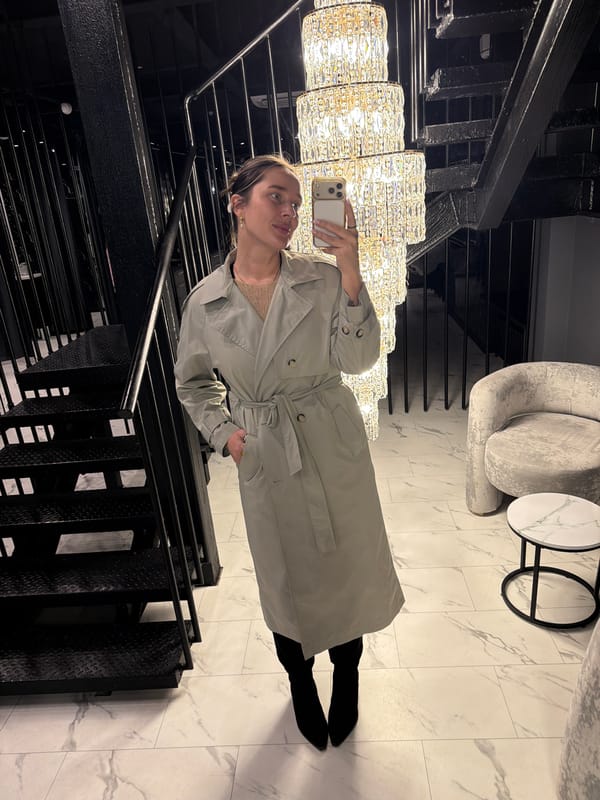 Woman takes selfie on staircase in Podolsk building lobby