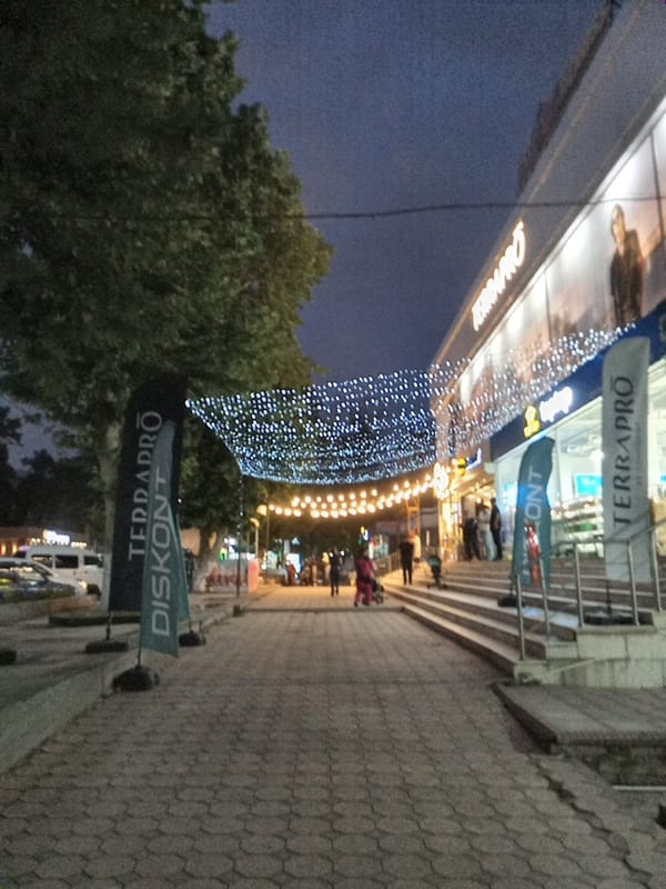 Dusk street scene along Angren's tree-lined sidewalks
