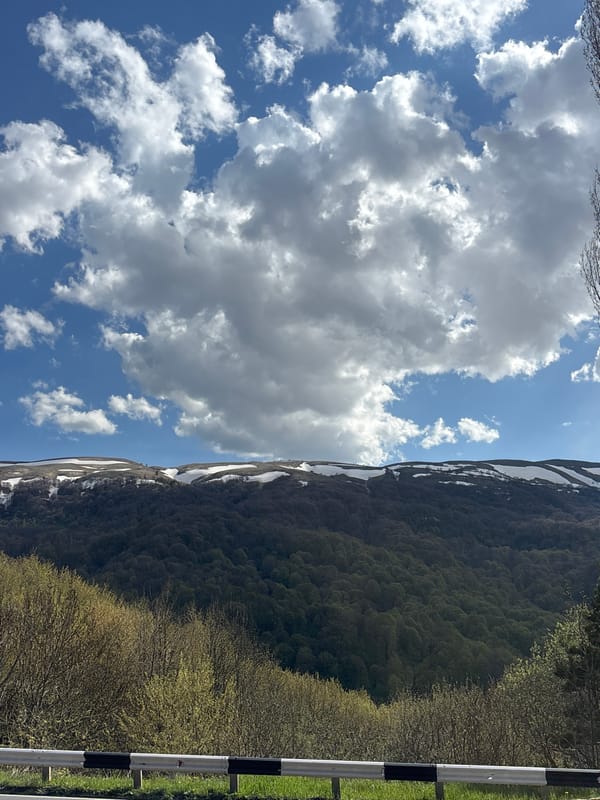 Travelers document ordinary mountain road moments in Dilijan, Armenia