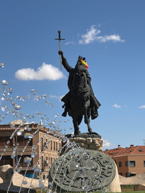 Toledo's Alfonso VI statue and historic city center, summer morning