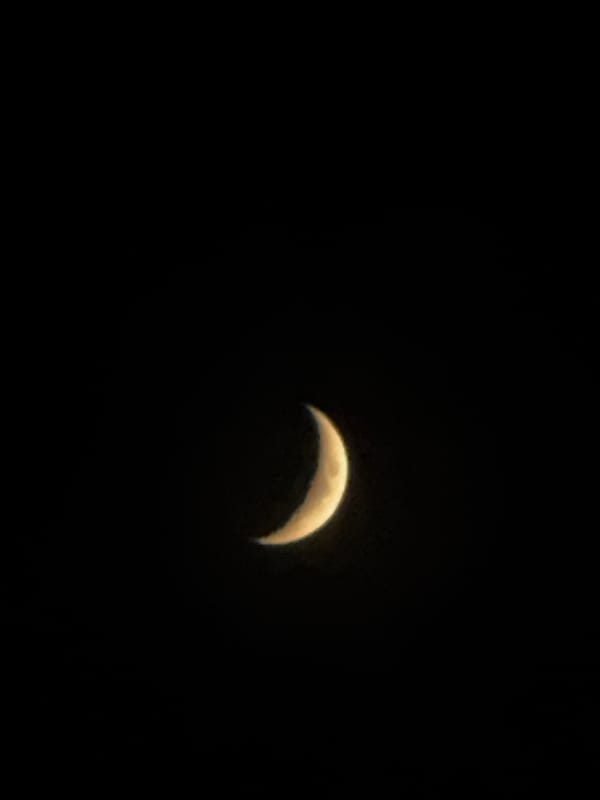 Crescent moon observed in night sky over Kazan, Russia