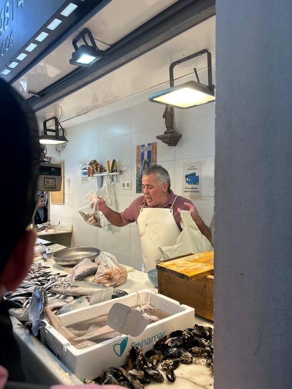 Man at fish market stall in Málaga