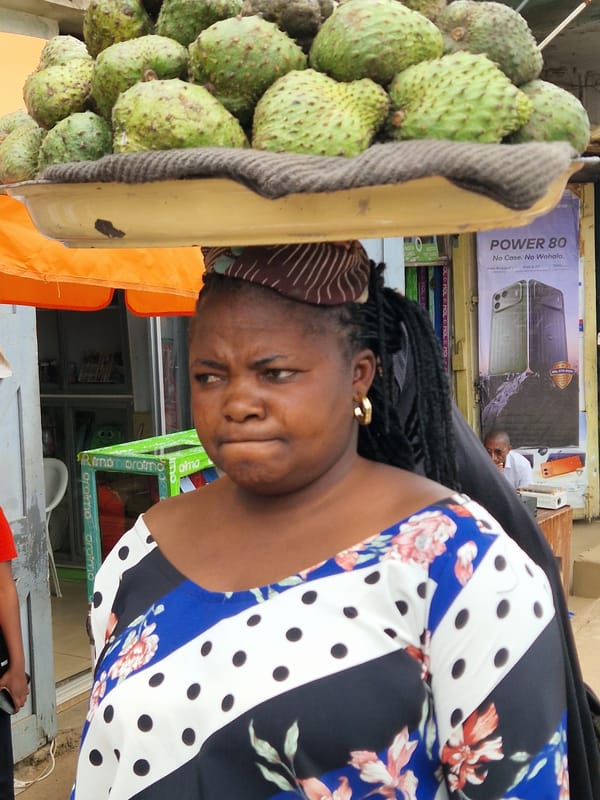 Street life and vendors in Jos, Nigeria at midday