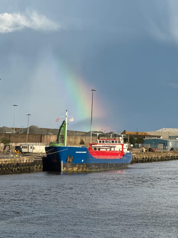 Rainbow appears over Great Yarmouth port during afternoon