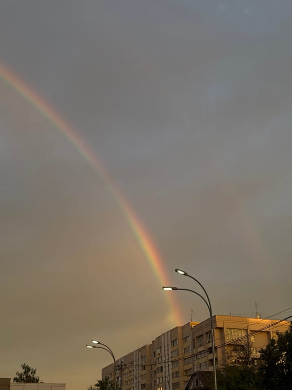 Rainbow over Nizhny Novgorod apartment blocks at golden hour