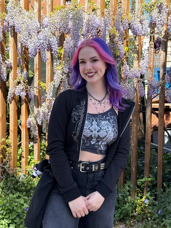 Woman takes selfies amid wisteria blossoms in Madrid
