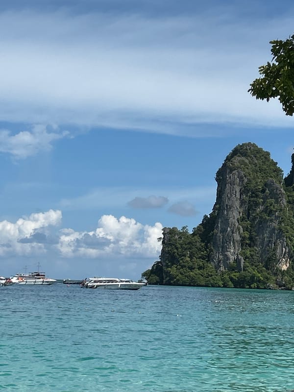 Quiet morning on the Ao Nang shoreline, boats on the bay