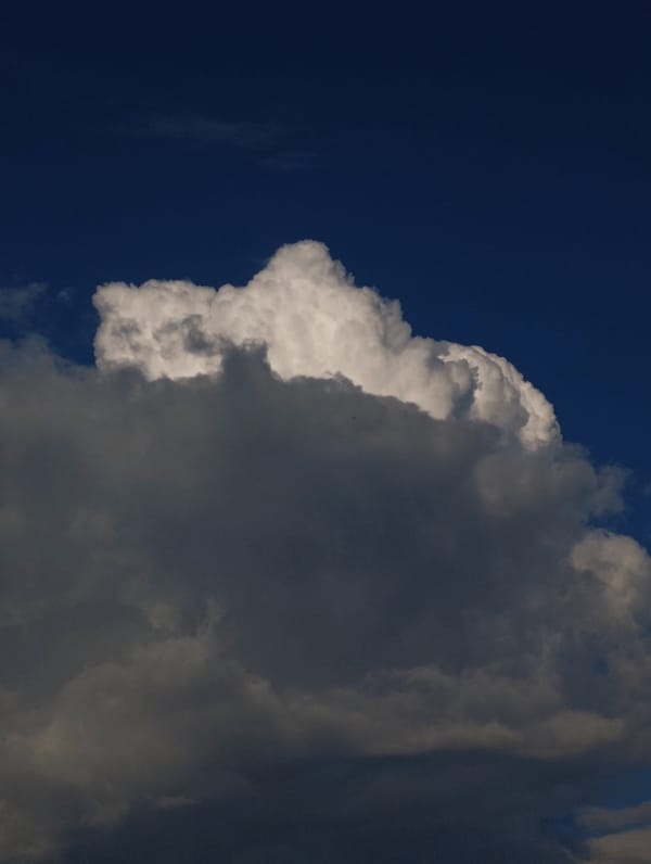 Massive storm cloud builds over a suburban neighborhood