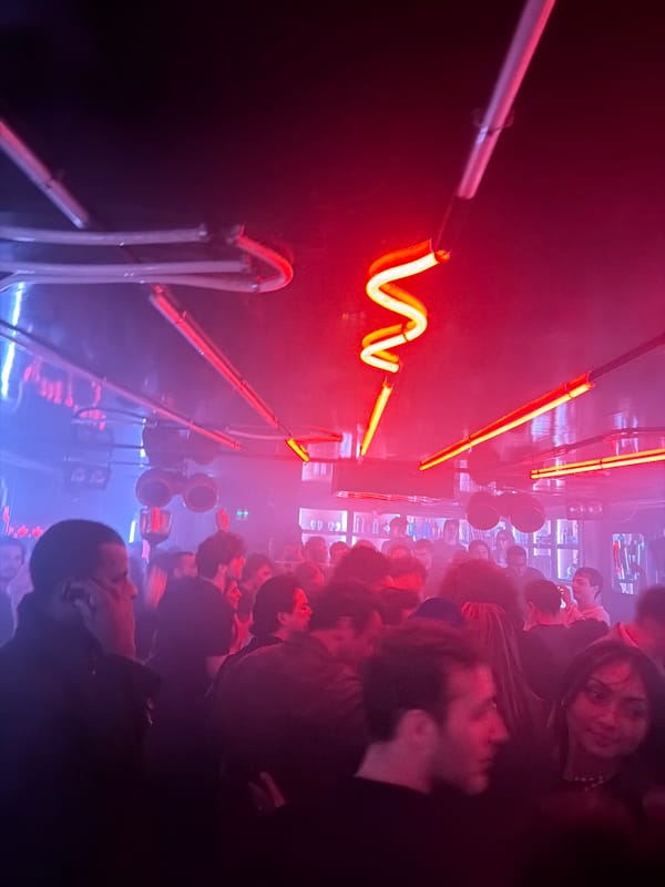 Early morning crowd gathered in dimly lit Paris interior