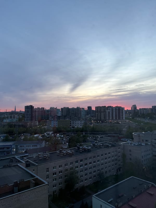 Twilight cityscape captured showing colorful sky over high-rise buildings