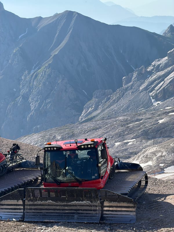 Mountain morning: groomer, coffee, and a rappel in the Alps