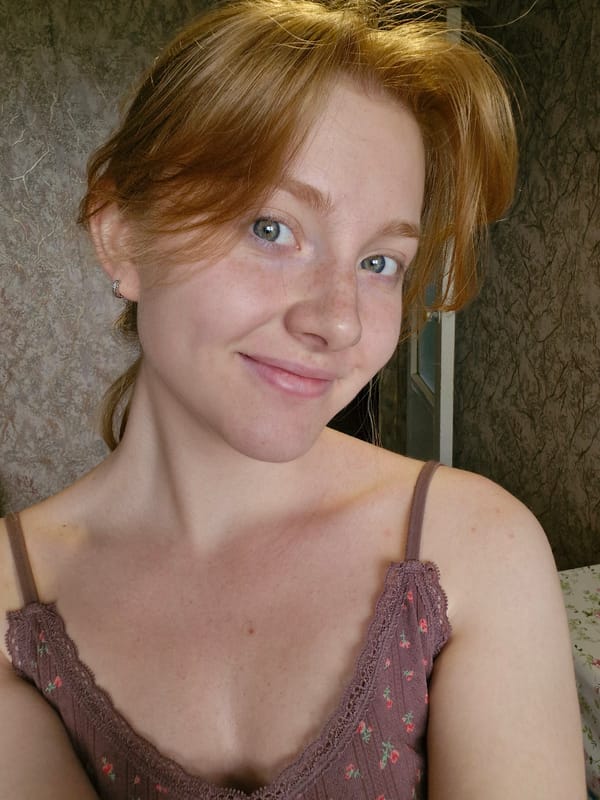 Woman in brown floral top photographed in morning portrait session