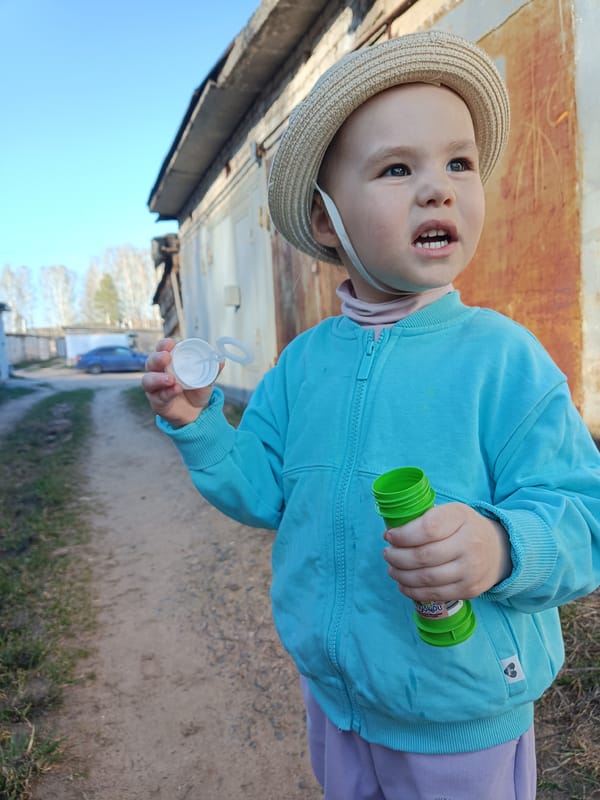 Child blows bubbles near waterfront in Chaikovsky, Russia