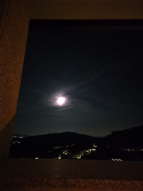 Moonlight captured reflecting on water in Barcelos, Portugal