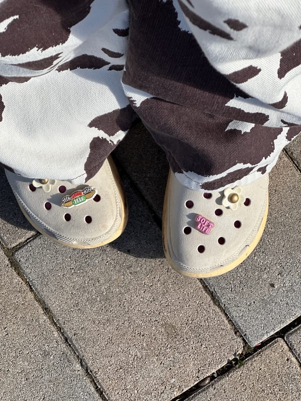 Person in decorated Crocs photographed on street in Šušanj